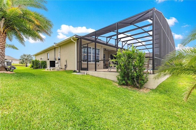 11215 SE 172nd Pl, Summerfield, FL 34491 - rear view of house with stucco siding, a patio, a yard, and glass enclosure