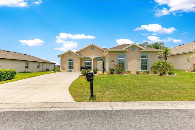 11215 SE 172nd Pl, Summerfield, FL 34491 - mediterranean / spanish house featuring driveway, stucco siding, and a front yard
