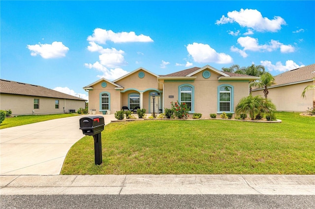 11215 SE 172nd Pl, Summerfield, FL 34491 - mediterranean / spanish house with stucco siding, a front yard, and driveway