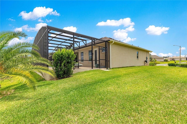 11215 SE 172nd Pl, Summerfield, FL 34491 - back of property featuring stucco siding, a lawn, a patio area, and a lanai