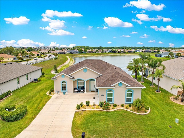 11215 SE 172nd Pl, Summerfield, FL 34491 - mediterranean / spanish-style home with driveway, stucco siding, a residential view, a shingled roof, and a front yard