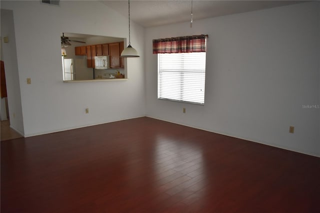 610 Swallow Ct, Apopka, FL 32712 - unfurnished room with wood finished floors, ceiling fan, vaulted ceiling, and baseboards