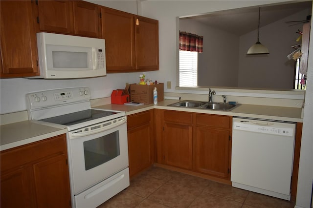 610 Swallow Ct, Apopka, FL 32712 - kitchen with white appliances, a sink, light countertops, light tile patterned floors, and brown cabinetry