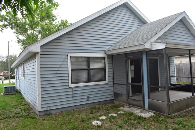 610 Swallow Ct, Apopka, FL 32712 - back of property with a sunroom and roof with shingles