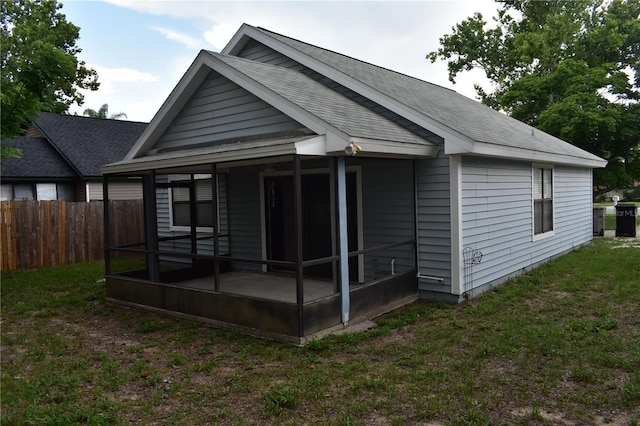 610 Swallow Ct, Apopka, FL 32712 - rear view of house featuring a sunroom and roof with shingles