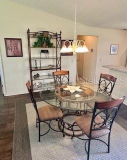 3337 Candlebrook St, The Villages, FL 32162 - dining room featuring baseboards, a textured ceiling, and wood finished floors