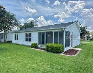 3337 Candlebrook St, The Villages, FL 32162 - back of house featuring a lawn