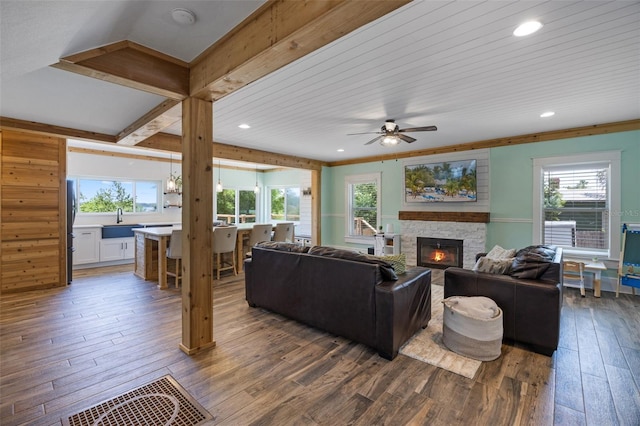 378 W Osceola St, Clermont, FL 34711 - living area featuring wood-type flooring, plenty of natural light, a stone fireplace, and recessed lighting
