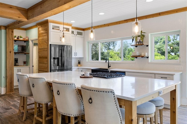 378 W Osceola St, Clermont, FL 34711 - kitchen with stainless steel appliances, a sink, open shelves, dark wood-style floors, and decorative backsplash