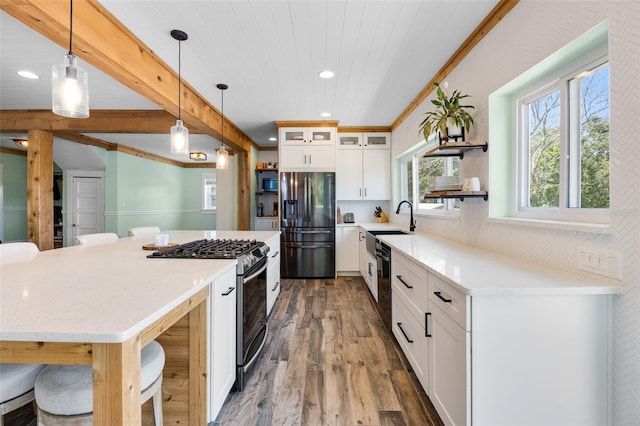 378 W Osceola St, Clermont, FL 34711 - kitchen with appliances with stainless steel finishes, wood finished floors, open shelves, white cabinets, and recessed lighting