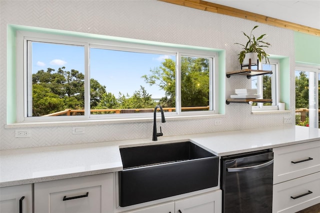 378 W Osceola St, Clermont, FL 34711 - kitchen with a sink, dishwasher, decorative backsplash, white cabinetry, and light stone counters