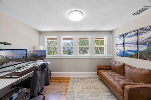 378 W Osceola St, Clermont, FL 34711 - home office with baseboards, wood finished floors, and a textured ceiling