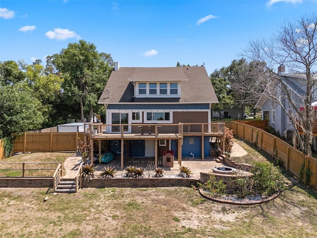378 W Osceola St, Clermont, FL 34711 - back of property with a deck, a patio area, a shingled roof, an outdoor fire pit, and stairs