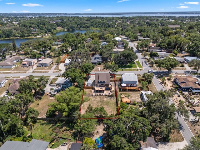 378 W Osceola St, Clermont, FL 34711 - aerial view of residential area with a nearby body of water, property boundaries highlighted, and a tree filled landscape