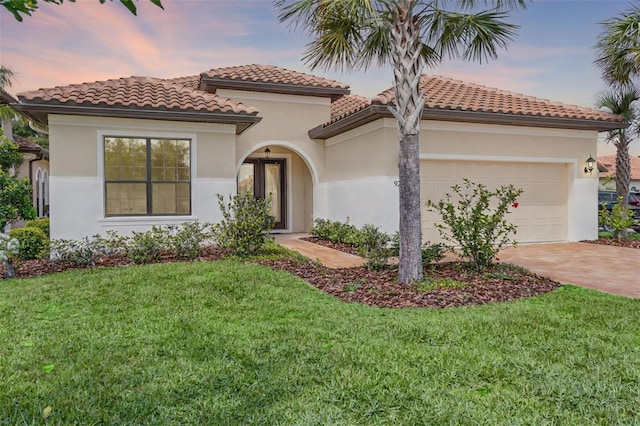 9220 San Jose Blvd, Howey In The Hills, FL 34737 - mediterranean / spanish-style home with concrete driveway, stucco siding, an attached garage, a front lawn, and a tiled roof
