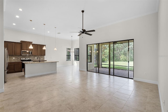 9220 San Jose Blvd, Howey In The Hills, FL 34737 - unfurnished living room with ceiling fan, baseboards, recessed lighting, light tile patterned floors, and crown molding