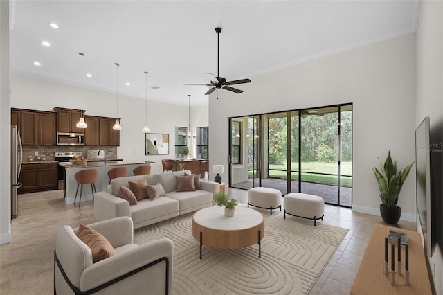 9220 San Jose Blvd, Howey In The Hills, FL 34737 - living room with a ceiling fan, recessed lighting, light tile patterned floors, a high ceiling, and ornamental molding