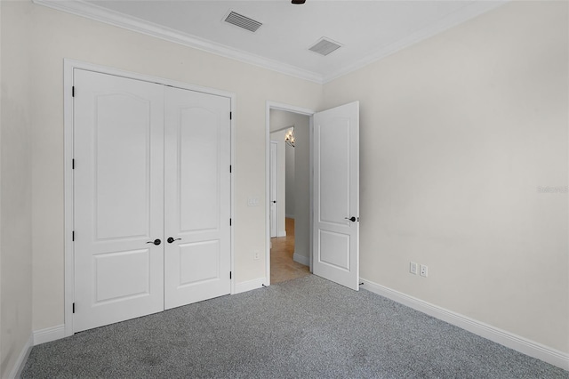 9220 San Jose Blvd, Howey In The Hills, FL 34737 - unfurnished bedroom featuring carpet flooring, ornamental molding, baseboards, and a closet