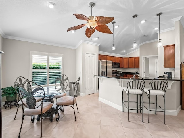 654 Poinsett Ct, The Villages, FL 32162 - dining space with a ceiling fan, vaulted ceiling, ornamental molding, baseboards, and light tile patterned floors