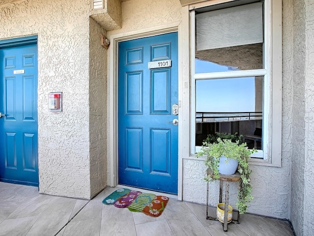 3425 S Atlantic Ave Unit 1101, Daytona Beach, FL 32118 - doorway to property with stucco siding and covered porch
