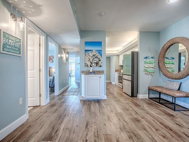 3425 S Atlantic Ave Unit 1101, Daytona Beach, FL 32118 - hallway with light wood finished floors and baseboards
