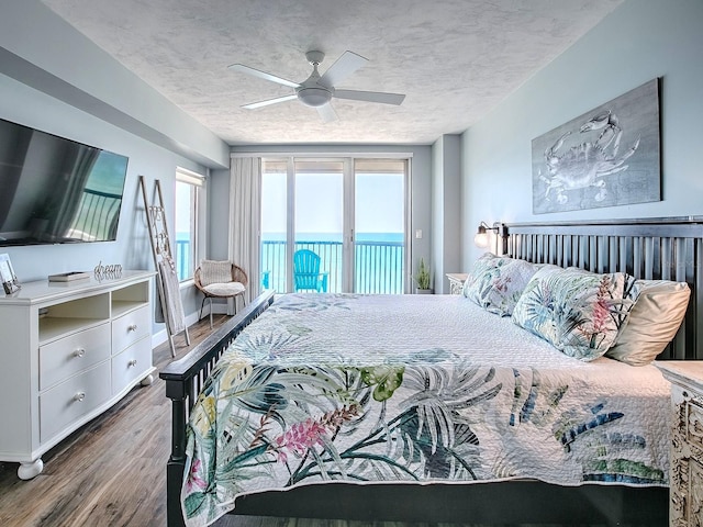 3425 S Atlantic Ave Unit 1101, Daytona Beach, FL 32118 - bedroom with access to outside, wood finished floors, a ceiling fan, and a water view