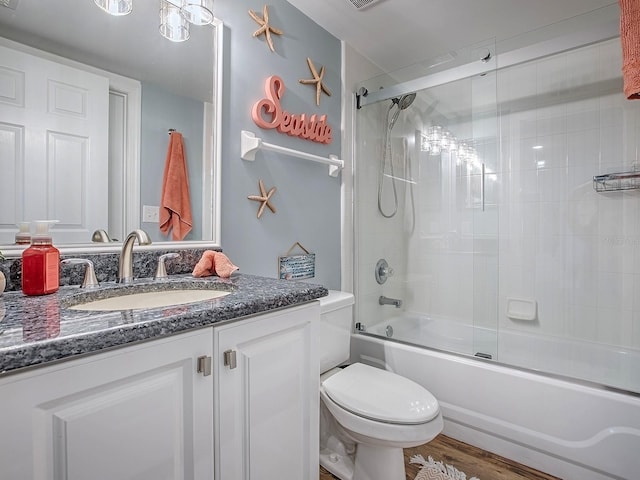 3425 S Atlantic Ave Unit 1101, Daytona Beach, FL 32118 - bathroom featuring vanity, toilet, and shower / bath combination with glass door