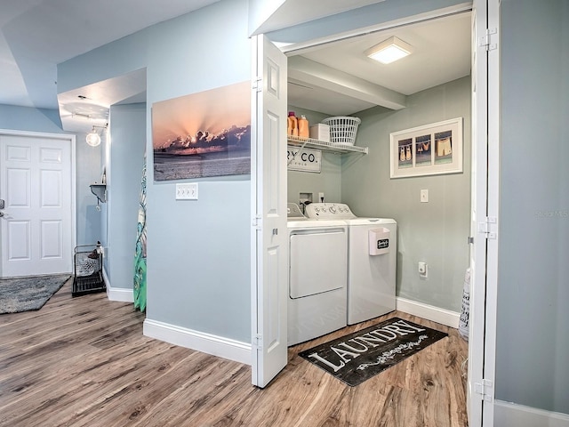 3425 S Atlantic Ave Unit 1101, Daytona Beach, FL 32118 - laundry room featuring washer and clothes dryer, wood finished floors, and baseboards