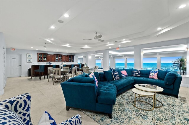 3425 S Atlantic Ave Unit 1101, Daytona Beach, FL 32118 - living room featuring a raised ceiling, ceiling fan, recessed lighting, light tile patterned floors, and a water view