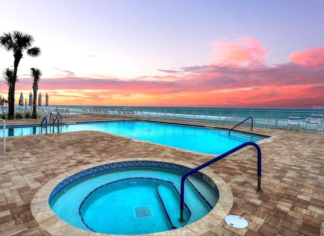 3425 S Atlantic Ave Unit 1101, Daytona Beach, FL 32118 - community pool featuring a hot tub, a patio, and a water view