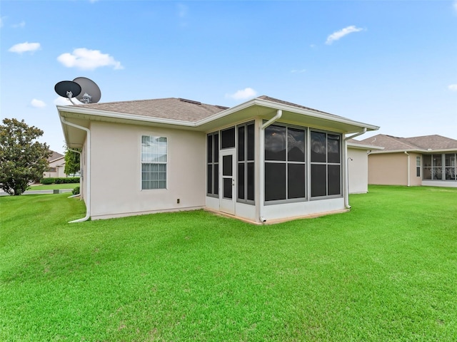 11019 SE 170th Lane Rd, Summerfield, FL 34491 - back of property with a sunroom, a lawn, and stucco siding