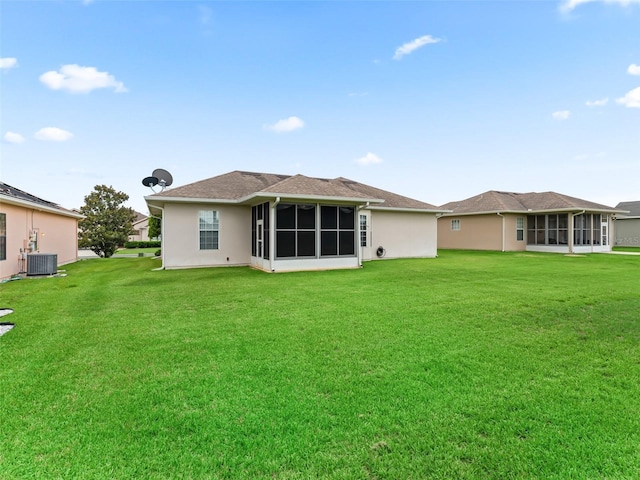 11019 SE 170th Lane Rd, Summerfield, FL 34491 - back of house with a sunroom, central AC, and a yard