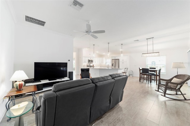3769 Causey Ct, The Villages, FL 32163 - living area featuring a ceiling fan, ornamental molding, and baseboards