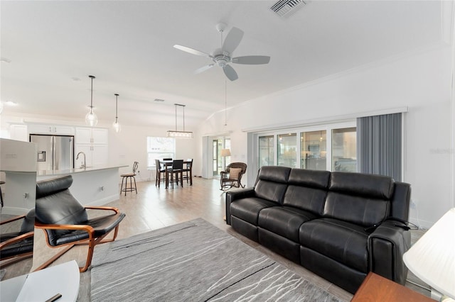 3769 Causey Ct, The Villages, FL 32163 - living area featuring ceiling fan, light wood-type flooring, baseboards, and ornamental molding
