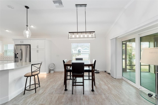 3769 Causey Ct, The Villages, FL 32163 - dining room featuring crown molding, plenty of natural light, light wood-type flooring, and baseboards