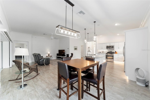 3769 Causey Ct, The Villages, FL 32163 - dining space with ceiling fan, ornamental molding, recessed lighting, and light wood-type flooring