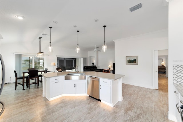 3769 Causey Ct, The Villages, FL 32163 - kitchen with dishwasher, a sink, light countertops, white cabinetry, and vaulted ceiling