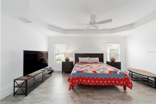 3769 Causey Ct, The Villages, FL 32163 - bedroom featuring a raised ceiling, baseboards, and a ceiling fan
