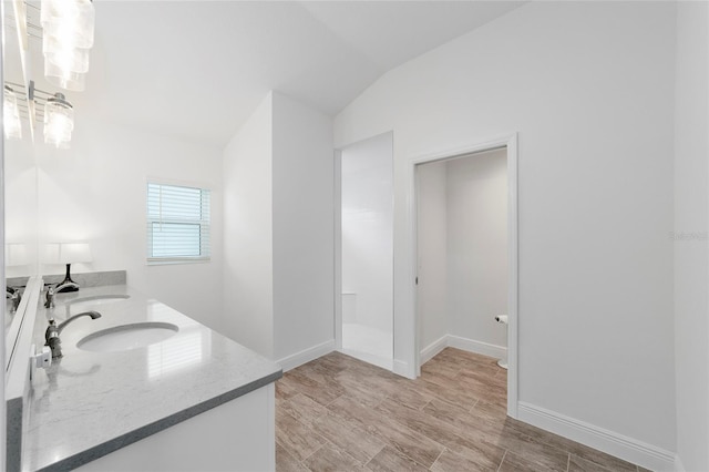 3769 Causey Ct, The Villages, FL 32163 - bathroom featuring double vanity, lofted ceiling, and baseboards