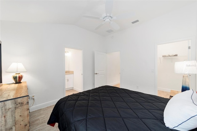 3769 Causey Ct, The Villages, FL 32163 - bedroom with lofted ceiling, a walk in closet, light wood finished floors, baseboards, and a ceiling fan