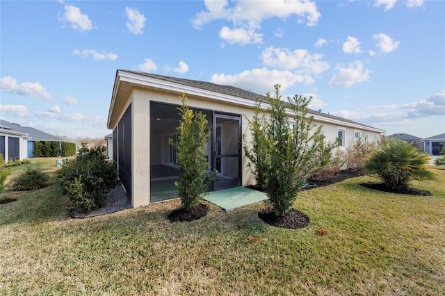 3769 Causey Ct, The Villages, FL 32163 - view of front facade with a sunroom, a front yard, and stucco siding