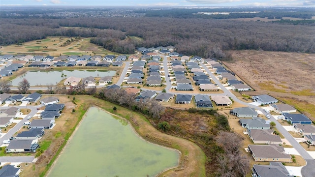 3769 Causey Ct, The Villages, FL 32163 - aerial view of property and surrounding area featuring nearby suburban area, a large body of water, and a heavily wooded area