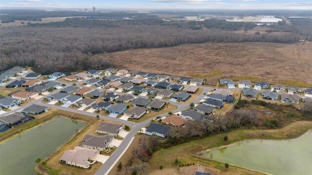 3769 Causey Ct, The Villages, FL 32163 - view of property location with a large body of water, nearby suburban area, and a heavily wooded area