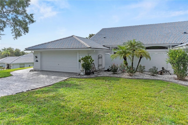 6048 Topsail Rd, Lady Lake, FL 32159 - ranch-style house featuring a tile roof, decorative driveway, a front lawn, and stucco siding