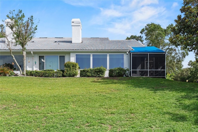 6048 Topsail Rd, Lady Lake, FL 32159 - back of house featuring a chimney, a yard, a tiled roof, and a sunroom