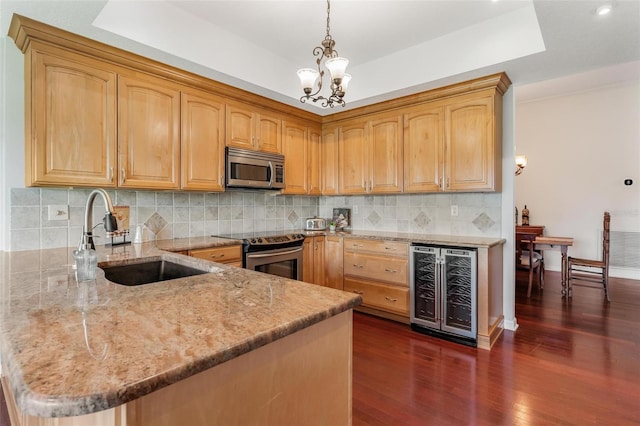 6048 Topsail Rd, Lady Lake, FL 32159 - kitchen featuring appliances with stainless steel finishes, beverage cooler, light stone countertops, dark wood finished floors, and a chandelier