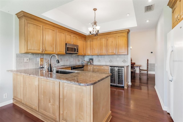 6048 Topsail Rd, Lady Lake, FL 32159 - kitchen featuring wine cooler, stainless steel microwave, freestanding refrigerator, dark wood finished floors, and a chandelier