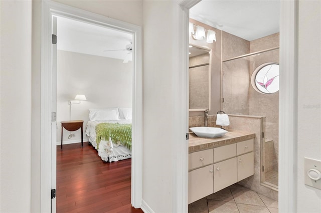 6048 Topsail Rd, Lady Lake, FL 32159 - ensuite bathroom with vanity, a shower stall, and wood finished floors
