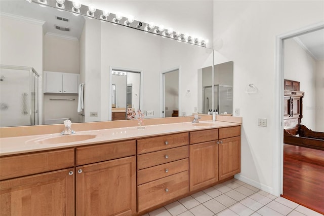 6048 Topsail Rd, Lady Lake, FL 32159 - ensuite bathroom featuring ornamental molding, tile patterned flooring, double vanity, a towering ceiling, and a shower stall
