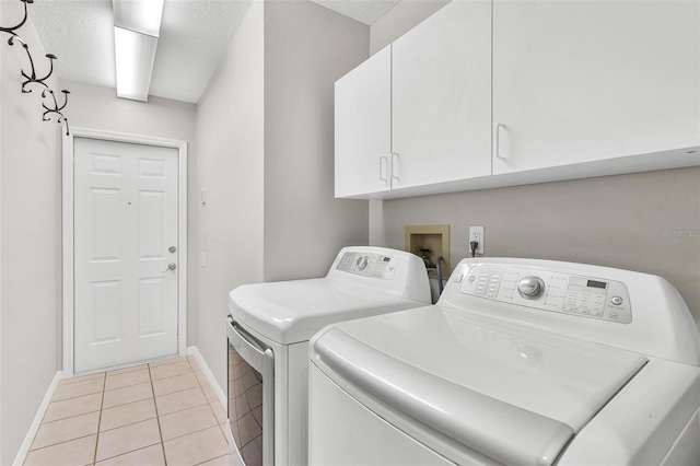 6048 Topsail Rd, Lady Lake, FL 32159 - laundry area featuring cabinet space, washer and dryer, light tile patterned flooring, and a textured ceiling